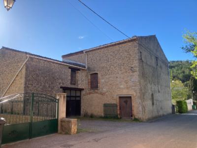 Two Houses With Outbuildings On An Enclosed Garden